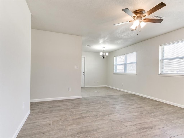 unfurnished room with visible vents, light wood-style flooring, and baseboards