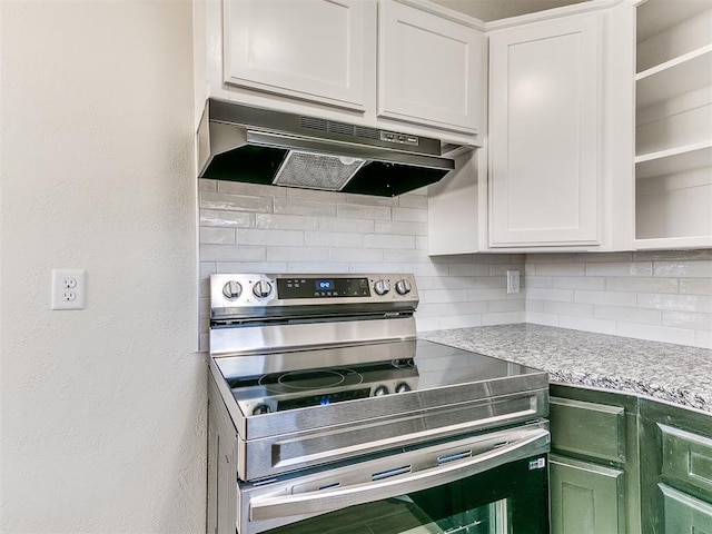 kitchen with stainless steel electric range oven, white cabinets, tasteful backsplash, and under cabinet range hood