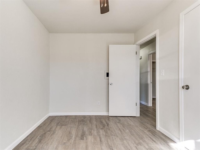 spare room with ceiling fan, baseboards, and wood finished floors