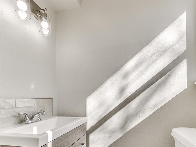 bathroom featuring toilet and vanity