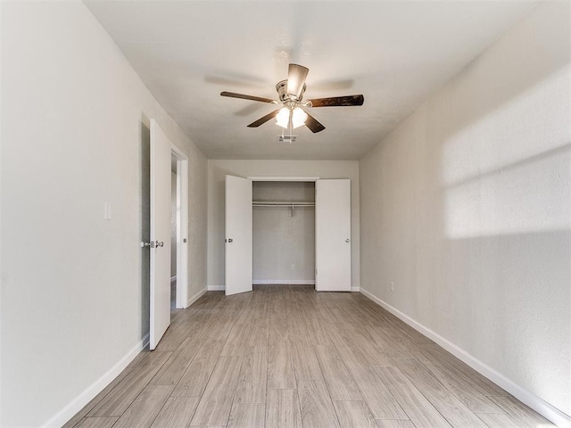 unfurnished bedroom with visible vents, a ceiling fan, a closet, light wood-style floors, and baseboards