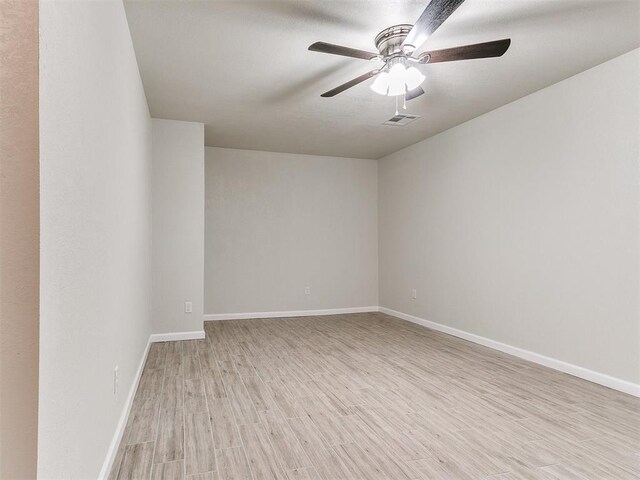 unfurnished room featuring visible vents, baseboards, light wood-style flooring, and a ceiling fan