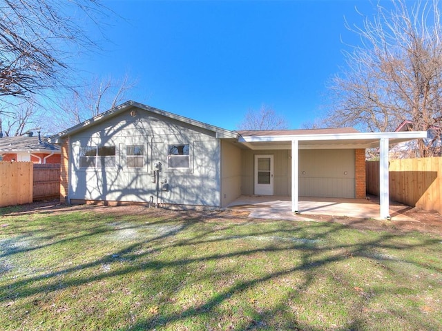 back of property with a patio area, a yard, and fence