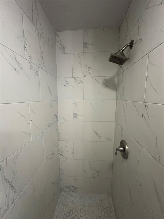 bathroom with a tile shower