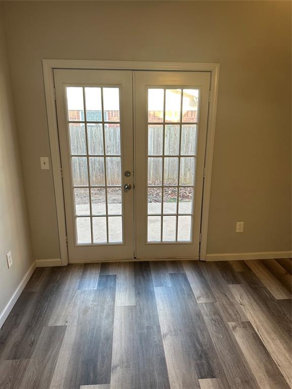 doorway to outside featuring a wealth of natural light, french doors, and dark wood-type flooring