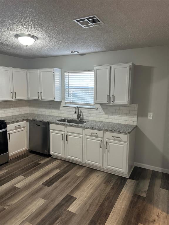 kitchen featuring dishwasher, dark wood-style floors, visible vents, and a sink