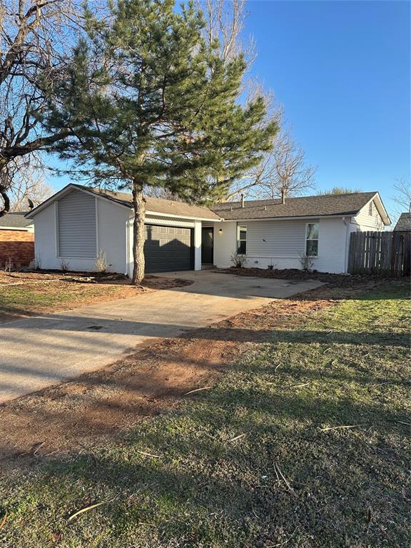 exterior space featuring an attached garage, fence, and driveway