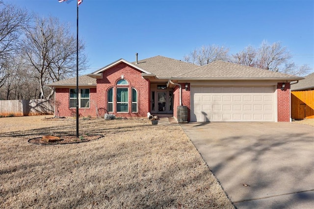 single story home featuring fence, a shingled roof, concrete driveway, a garage, and brick siding