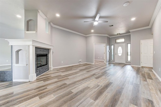 unfurnished living room featuring a stone fireplace, baseboards, visible vents, and light wood-type flooring