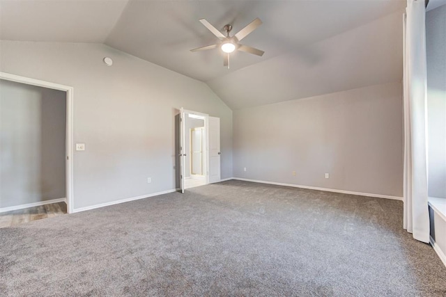 interior space with baseboards, ceiling fan, and vaulted ceiling