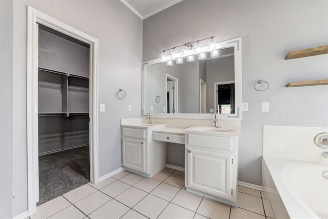 bathroom featuring tile patterned floors, a garden tub, two vanities, a sink, and a spacious closet