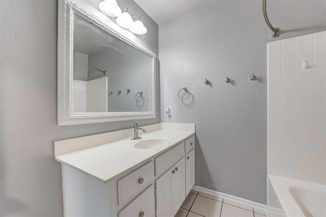 bathroom with tile patterned flooring, vanity, baseboards, and shower / bath combination