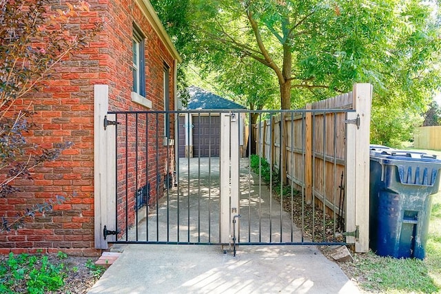 view of gate featuring an outdoor structure and fence