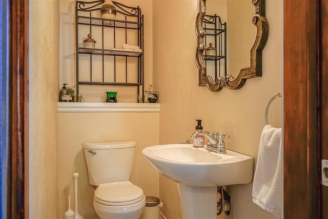 half bath featuring toilet