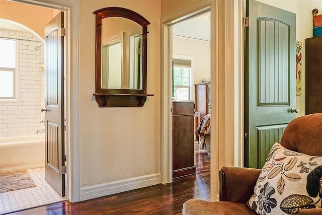 interior space featuring baseboards and wood finished floors