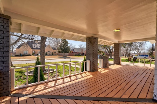 wooden deck with a residential view and a porch