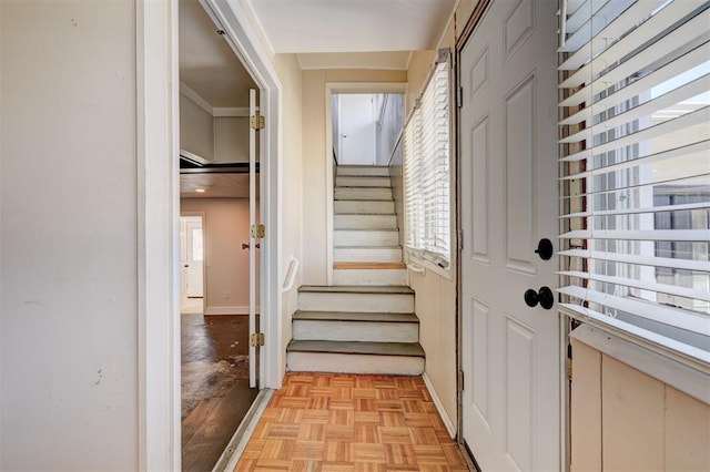 interior space with stairway and baseboards