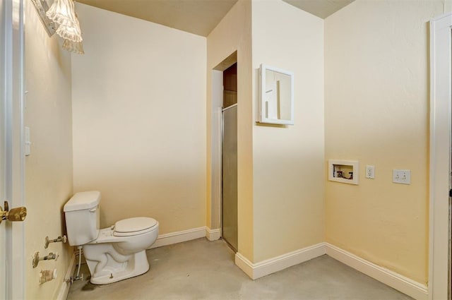 full bath featuring a stall shower, toilet, concrete flooring, and baseboards