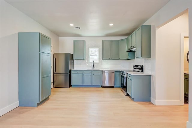 kitchen with visible vents, stainless steel appliances, light wood-type flooring, and a sink