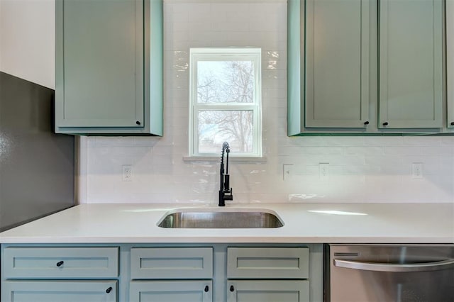 kitchen featuring decorative backsplash, dishwasher, light countertops, and a sink