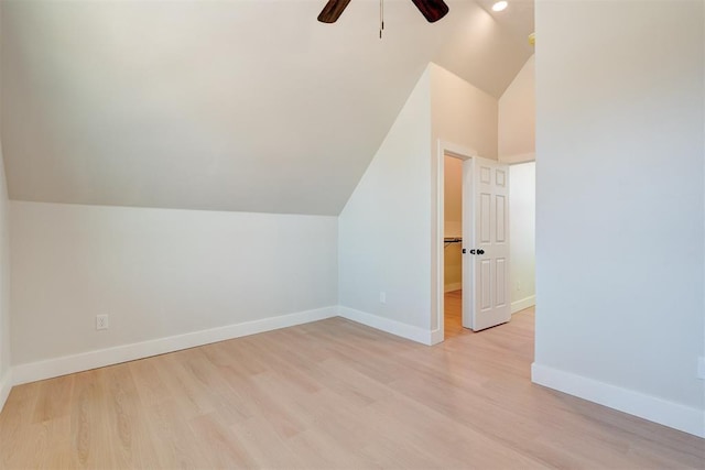 additional living space featuring vaulted ceiling, baseboards, and light wood finished floors