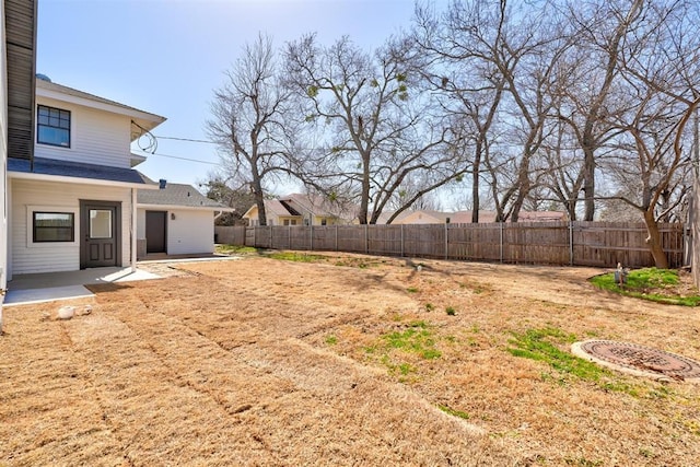 view of yard with a patio area and a fenced backyard