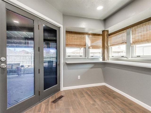 doorway featuring recessed lighting, baseboards, visible vents, and wood finish floors