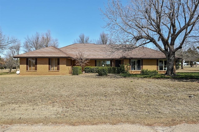 single story home featuring brick siding