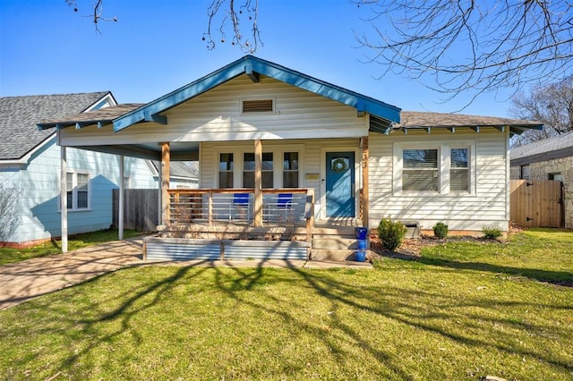 bungalow-style house with a porch, a front yard, and fence