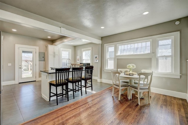 dining space featuring electric panel, recessed lighting, and baseboards