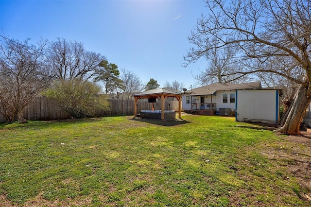 view of yard featuring a gazebo and a fenced backyard