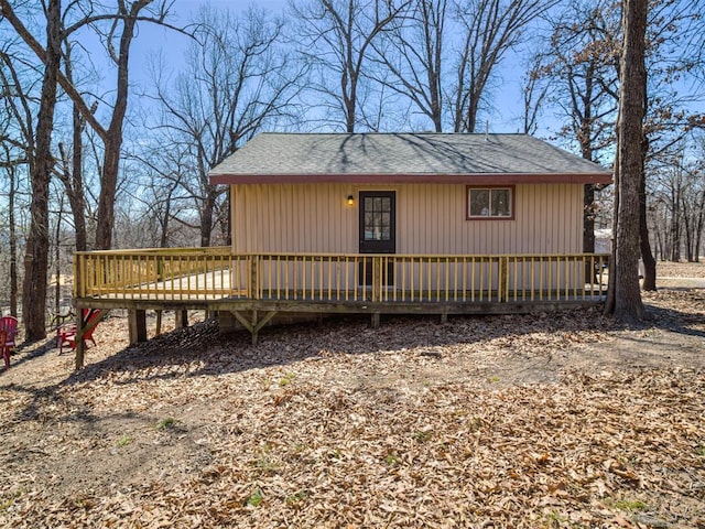 view of front of property with a deck and a shingled roof