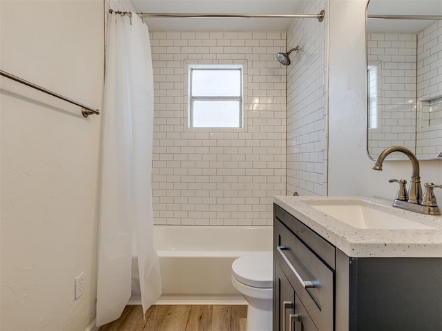 full bath featuring vanity, shower / tub combo, toilet, and wood finished floors