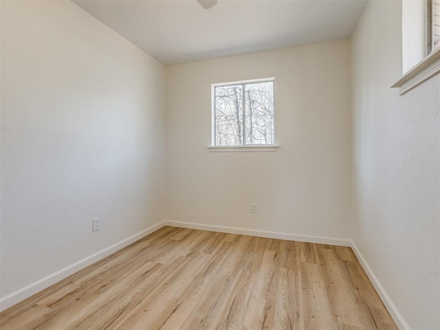 empty room with wood finished floors and baseboards