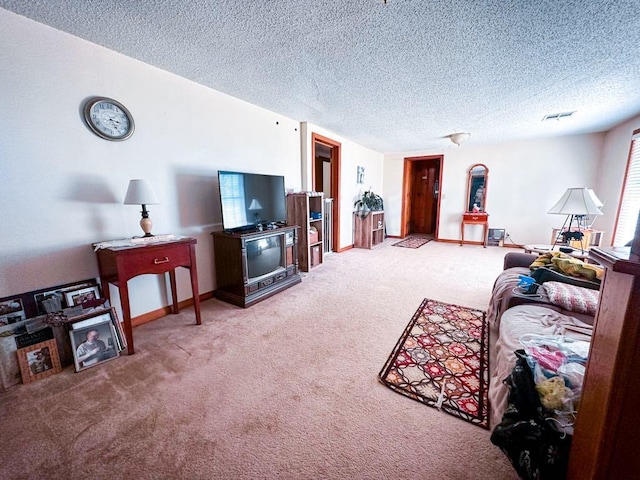 living room featuring baseboards, carpet floors, and a textured ceiling