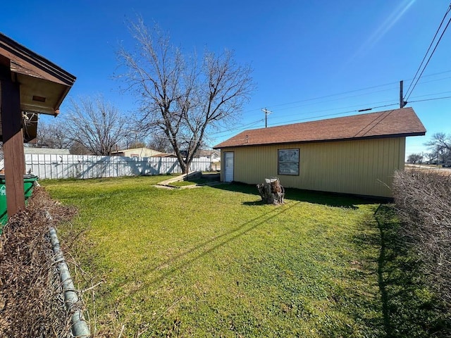 view of yard with an outbuilding and fence