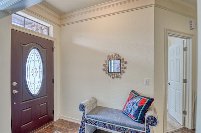 foyer with dark wood-style floors, baseboards, and ornamental molding