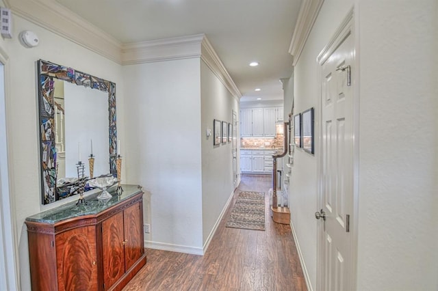 hallway featuring dark wood-style flooring, recessed lighting, baseboards, and ornamental molding