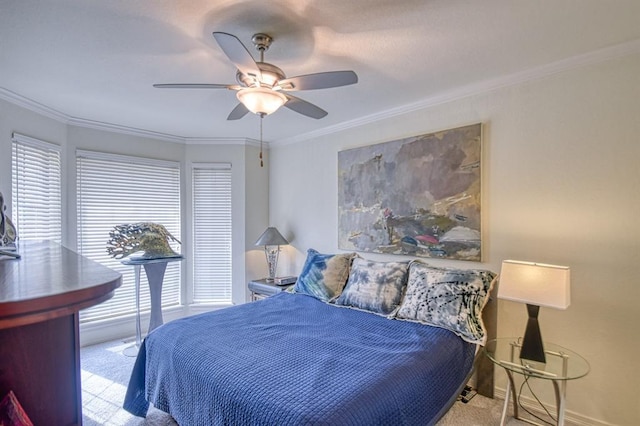 carpeted bedroom featuring crown molding, a ceiling fan, and baseboards