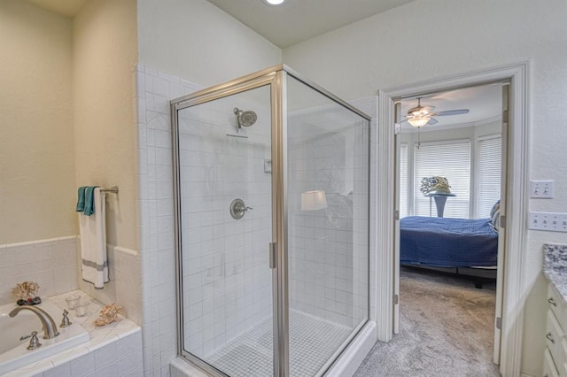 ensuite bathroom featuring vanity, a stall shower, a bath, ensuite bath, and a ceiling fan