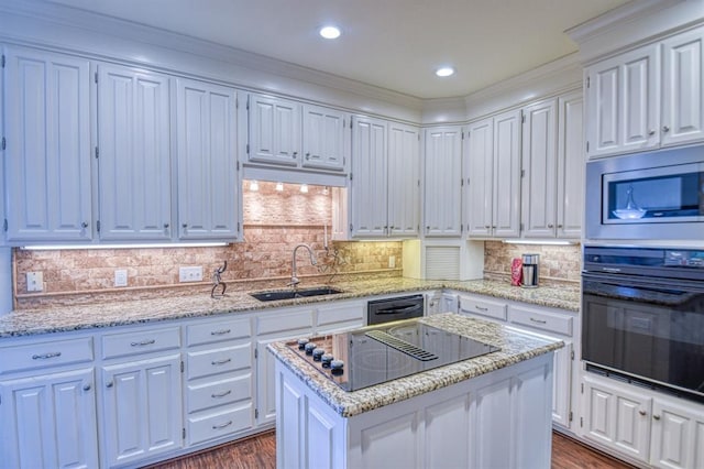 kitchen featuring dark wood-style flooring, white cabinetry, black appliances, and a sink