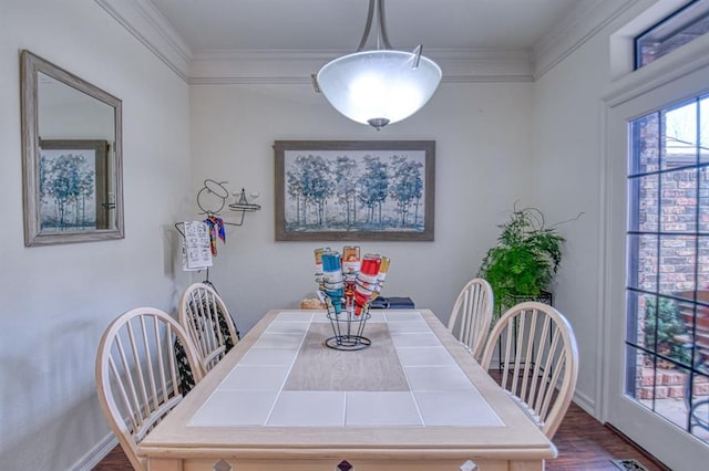 dining area with baseboards, dark wood finished floors, and crown molding