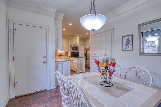 dining area featuring recessed lighting, wood finished floors, and ornamental molding