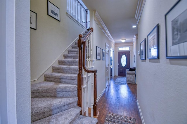 foyer entrance with stairway, wood finished floors, baseboards, recessed lighting, and crown molding