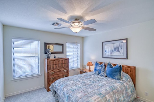 bedroom featuring visible vents, baseboards, a textured ceiling, and carpet flooring