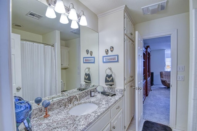 bathroom with visible vents, a chandelier, vanity, and tile patterned flooring