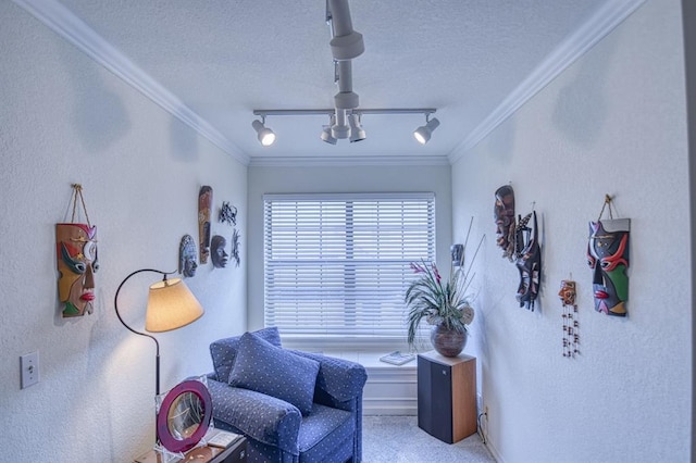 sitting room with rail lighting, a textured ceiling, and crown molding