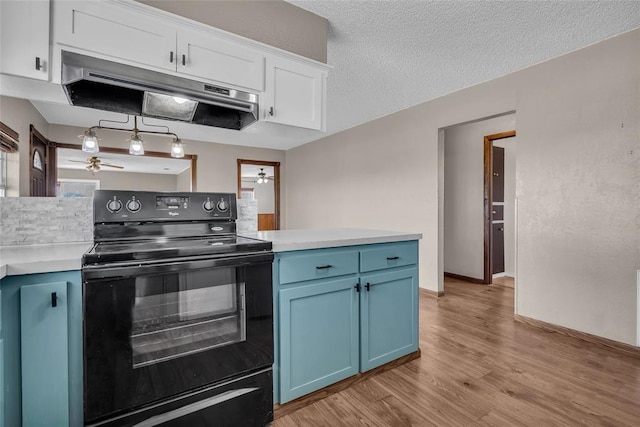 kitchen featuring white cabinetry, electric range, blue cabinets, and under cabinet range hood