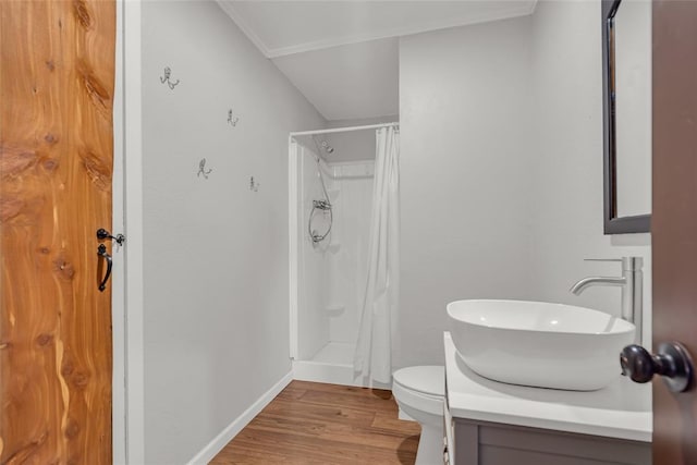 full bathroom with a shower with curtain, toilet, wood finished floors, baseboards, and vanity