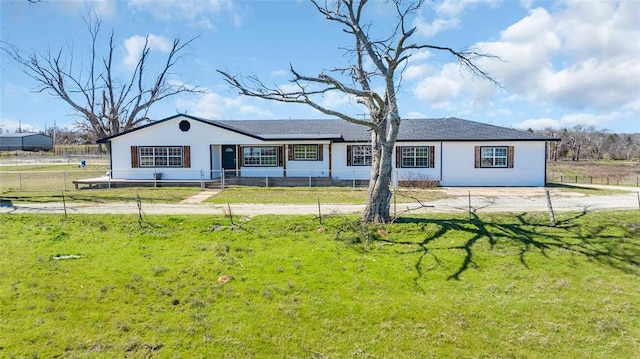 single story home featuring a front lawn and fence